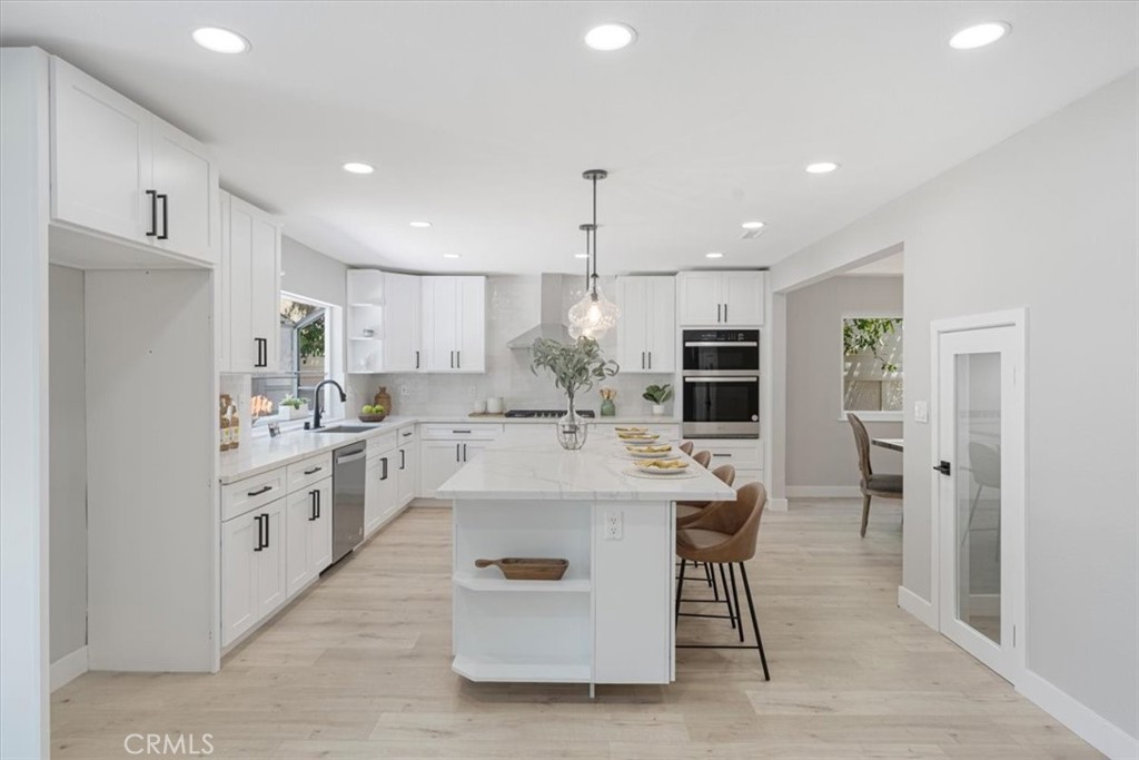 25032 Crystal Circle Lake Forest, CA 92630 - Photo 9 of 54 a large white kitchen with cabinets a sink and appliances