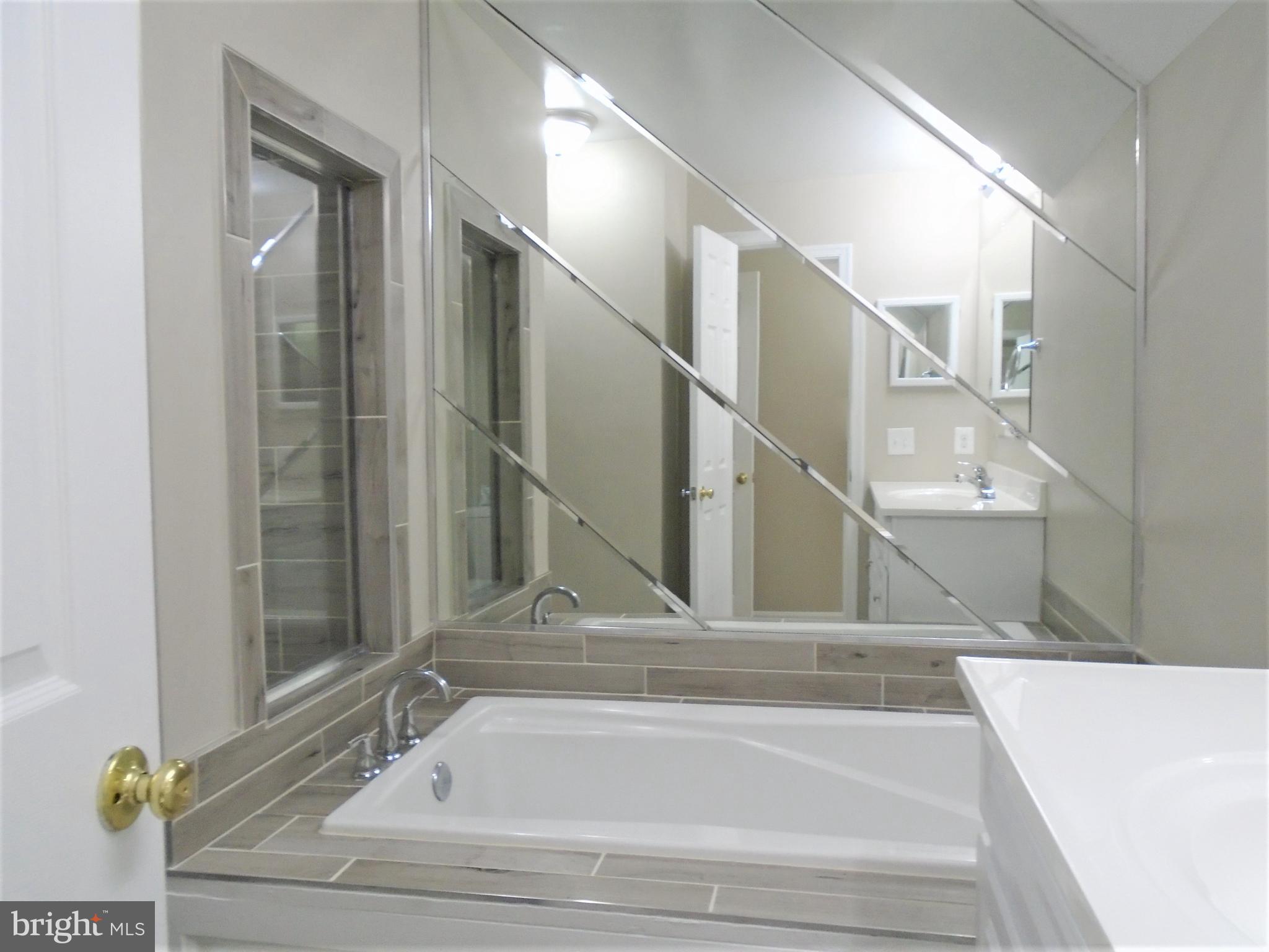 1914 Duffield Lane Alexandria, VA 22307 - Photo 28 of 50 a bathroom with bathtub and window