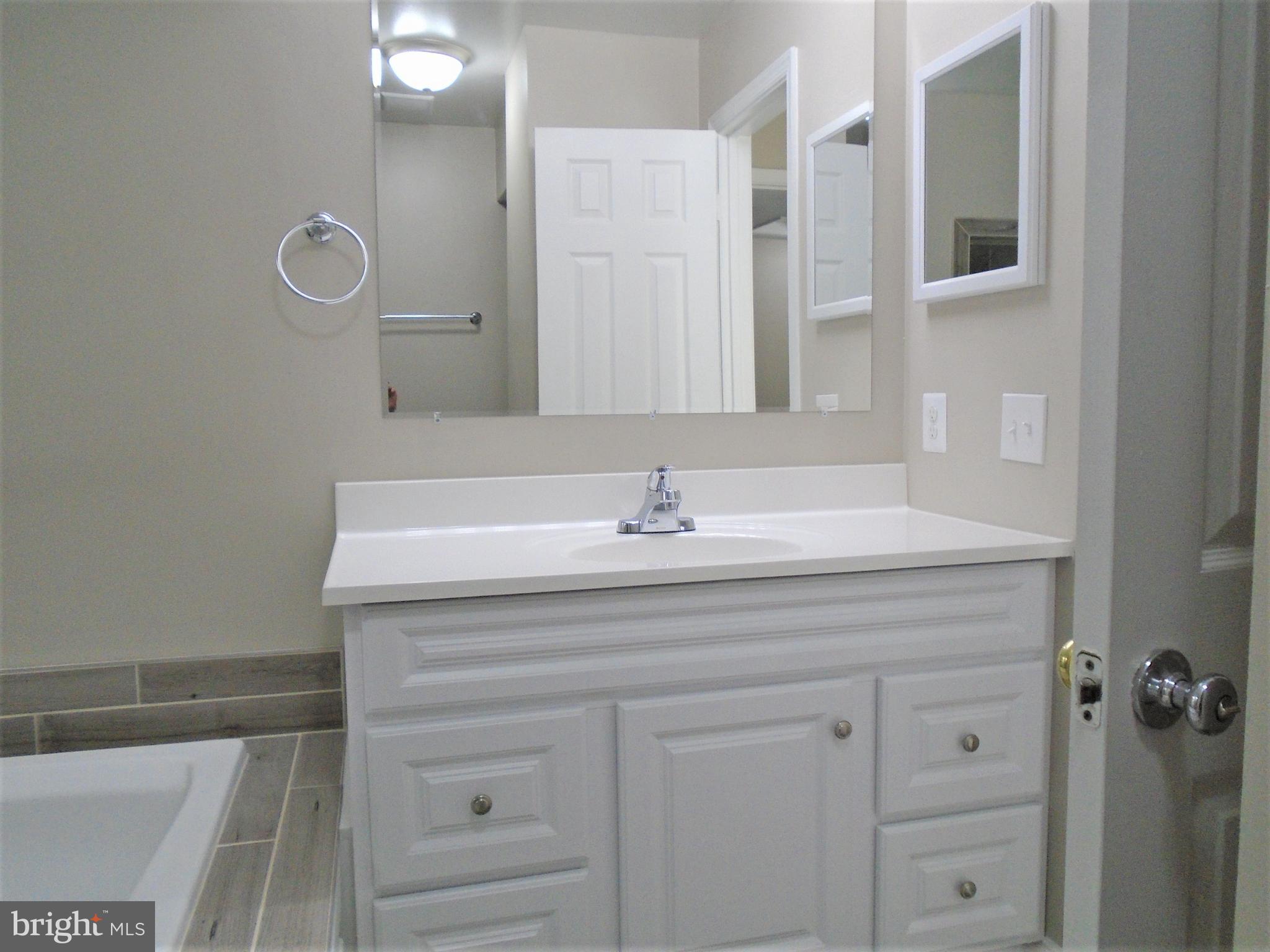 1914 Duffield Lane Alexandria, VA 22307 - Photo 33 of 50 a bathroom with a sink vanity and mirror