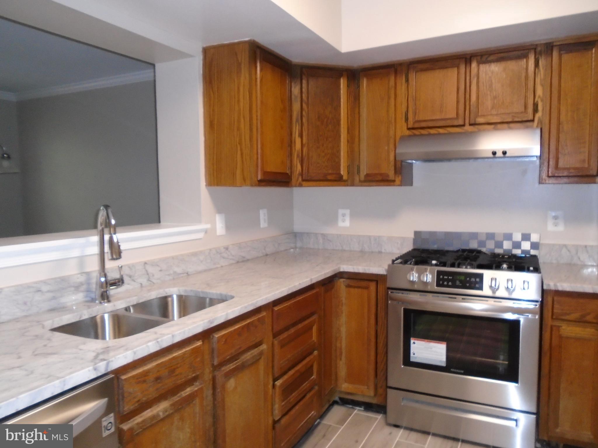 1914 Duffield Lane Alexandria, VA 22307 - Photo 4 of 50 a kitchen with granite countertop a sink stainless steel appliances and cabinets