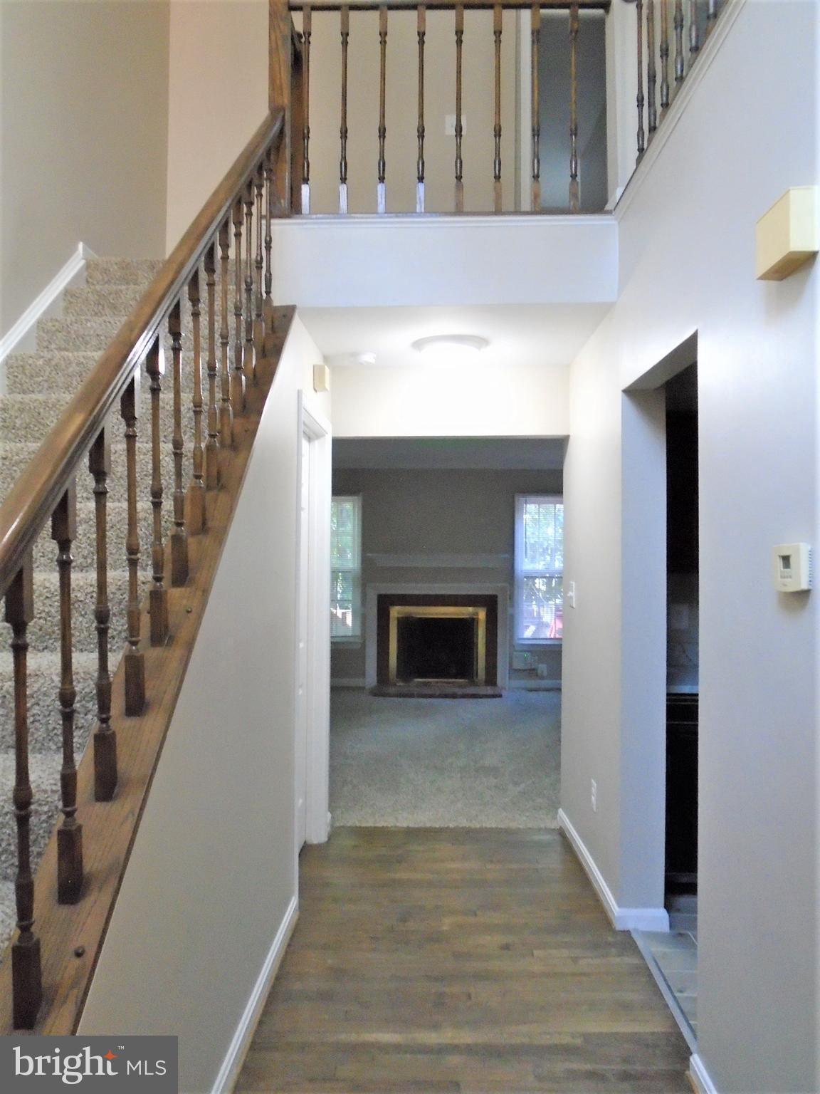 1914 Duffield Lane Alexandria, VA 22307 - Photo 7 of 50 a view of a hallway with wooden floor and staircase