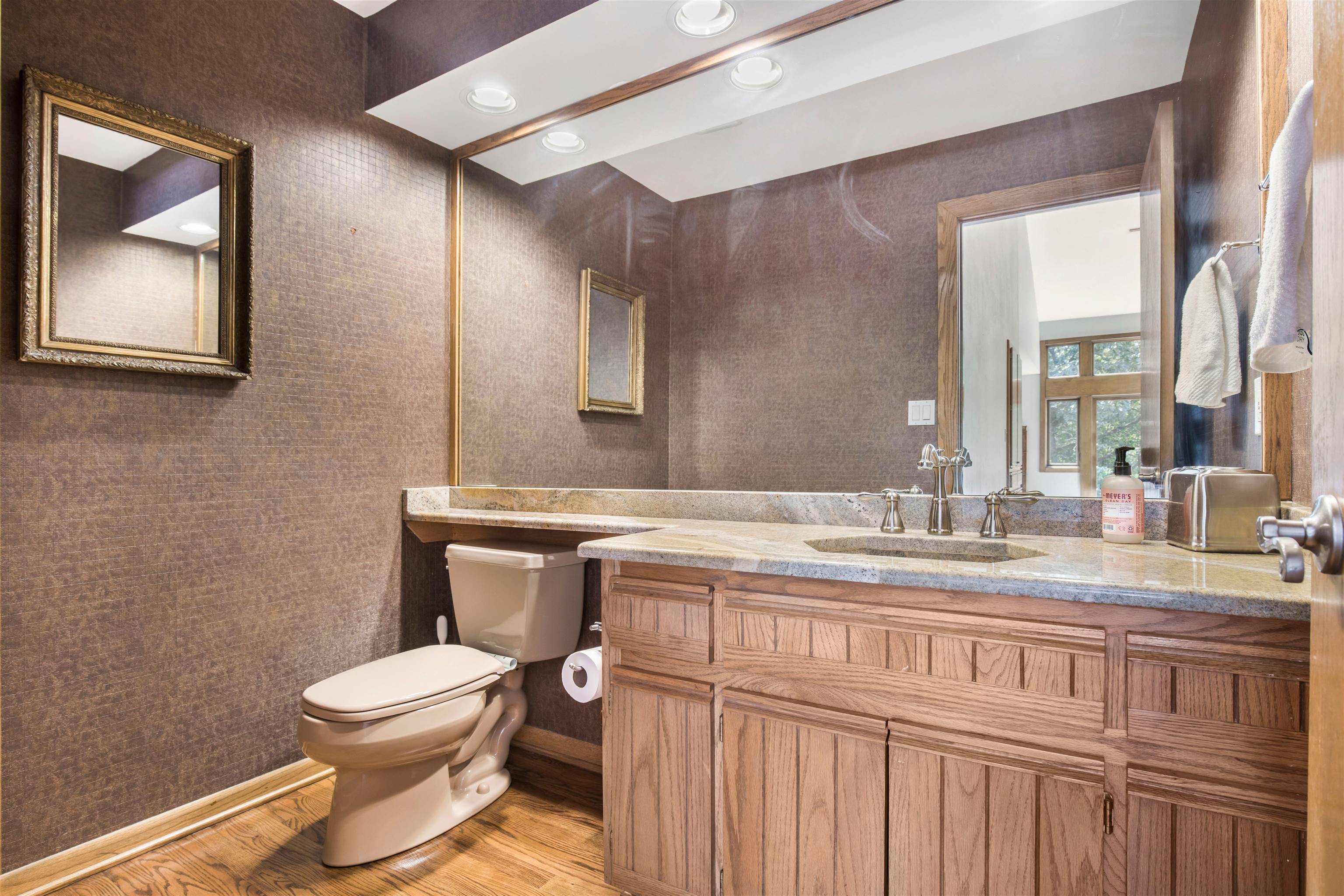 8024 Killarney Aire Road Roscoe, IL 61073 - Photo 23 of 45 a bathroom with a granite countertop toilet sink and mirror