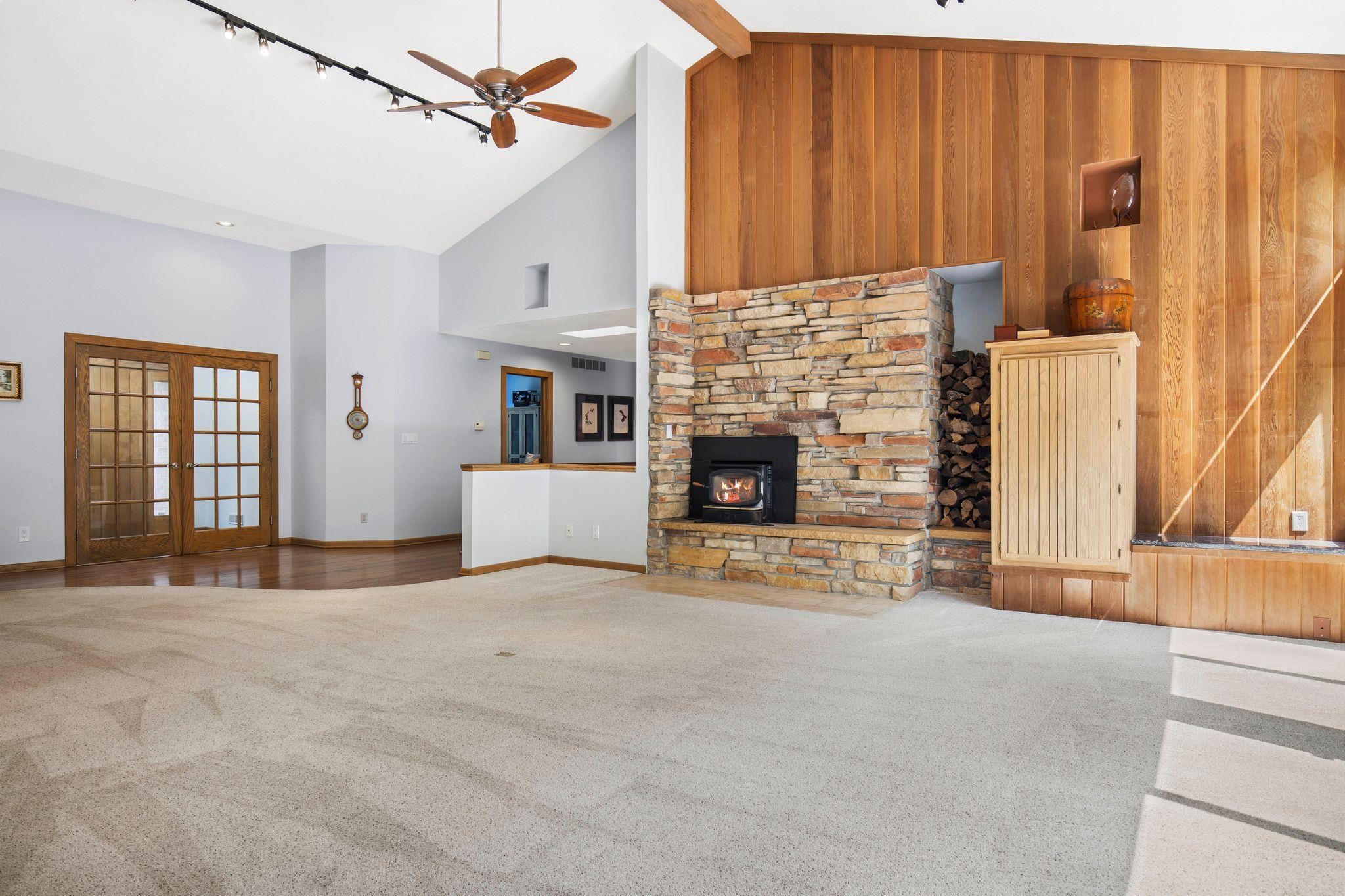 8024 Killarney Aire Road Roscoe, IL 61073 - Photo 3 of 45 an empty room with windows and a fireplace