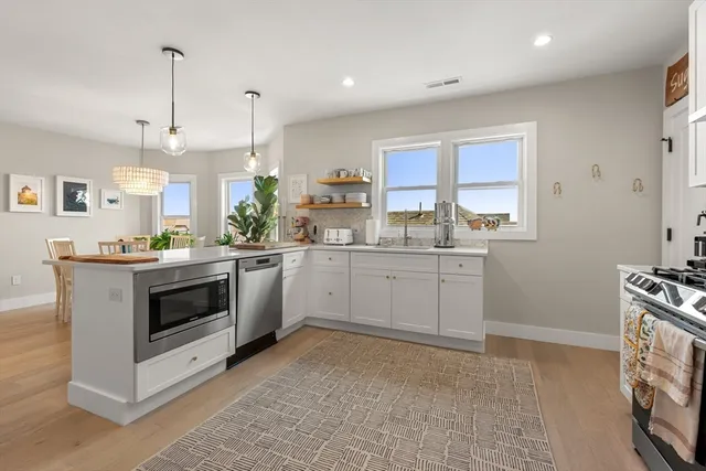 a kitchen with a stove a sink and a refrigerator