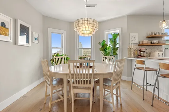 a view of a dining room with furniture window and wooden floor