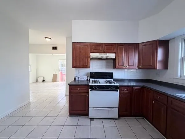 a kitchen with a stove top oven and cabinets