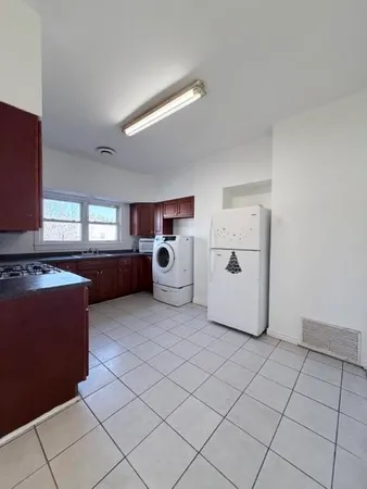 a room with a cabinets and white appliances