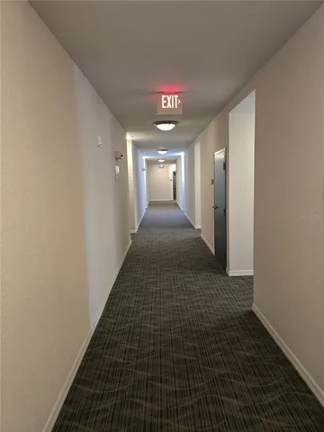 a large kitchen with stainless steel appliances a refrigerator a sink and a stove