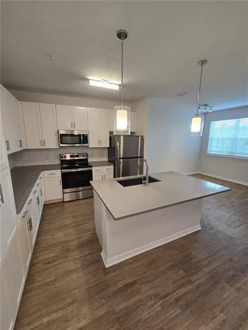 a spacious bathroom with a double vanity sink toilet and a tub