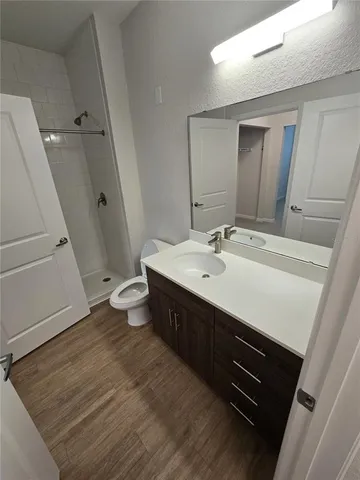 a bathroom with a toilet and a shower