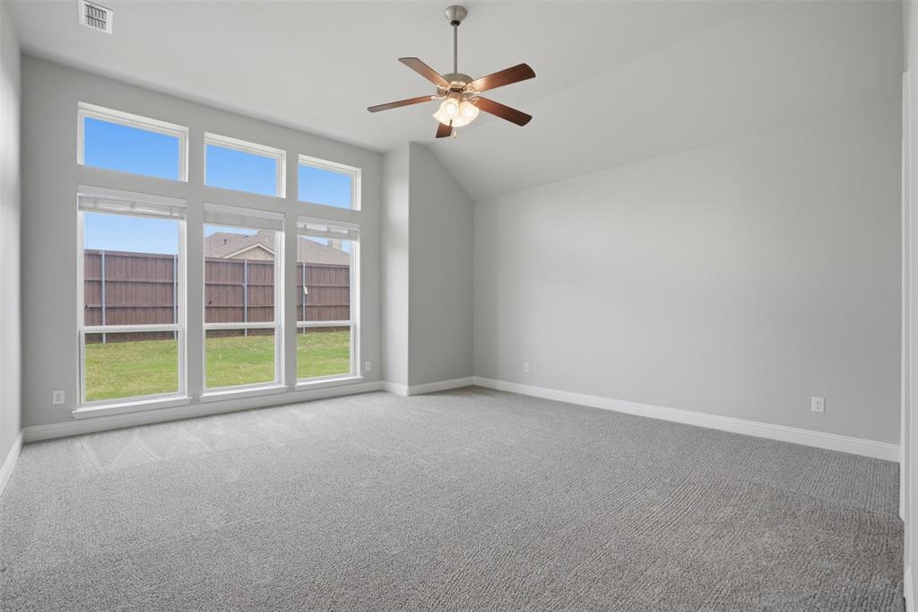 2217 Riviera Drive Little Elm, TX 75068 - Photo 15 of 36 Spacious room featuring a vaulted ceiling and a wood-finish ceiling fan