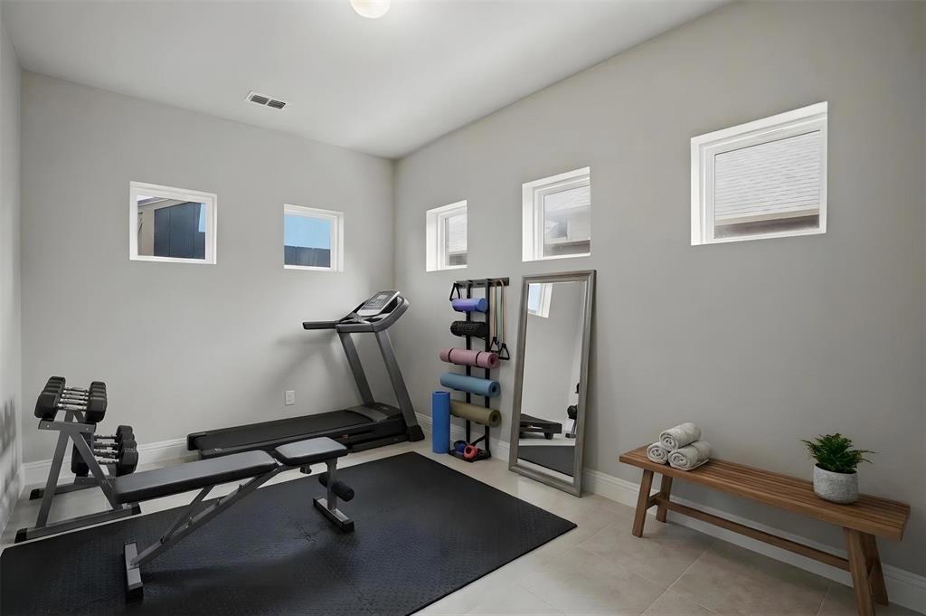 2217 Riviera Drive Little Elm, TX 75068 - Photo 18 of 36 Dedicated room featuring light gray walls, recessed lighting, and multiple square windows