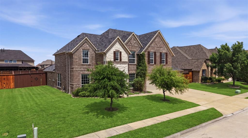 2217 Riviera Drive Little Elm, TX 75068 - Photo 2 of 36 Two-story brick and stone facade residence featuring multiple gables and dark shingle roofing