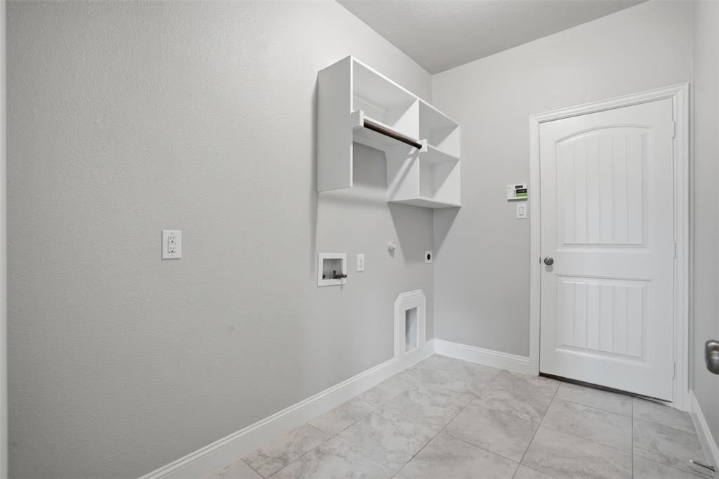 2217 Riviera Drive Little Elm, TX 75068 - Photo 21 of 36 Utility area featuring tile flooring, white baseboards, and neutral wall tones