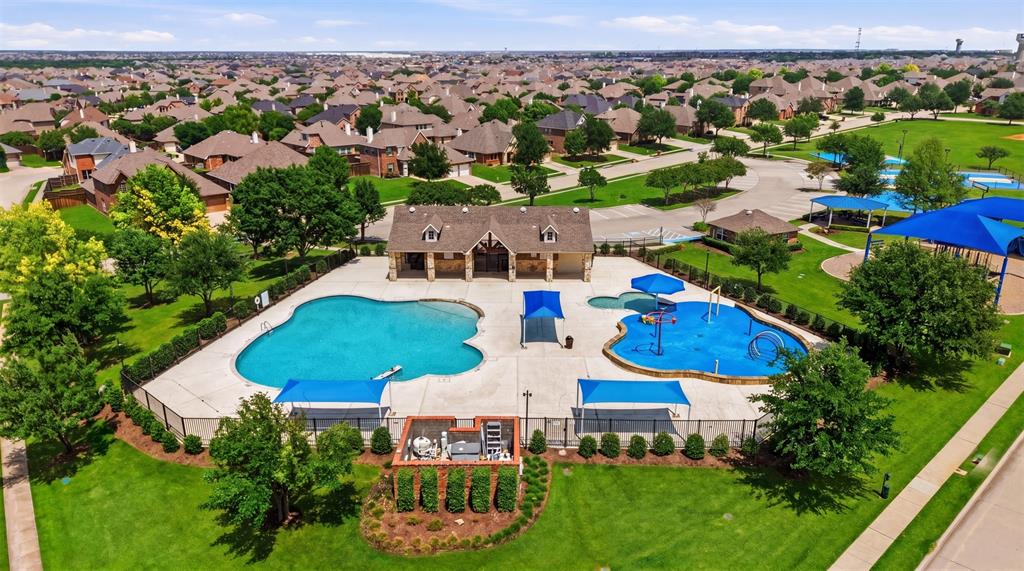 2217 Riviera Drive Little Elm, TX 75068 - Photo 34 of 36 Community amenity center featuring a large swimming pool, a separate children's splash pad, and a shaded pergola area