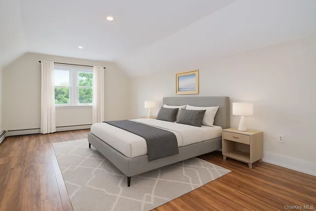 a spacious bedroom with a bed and a window