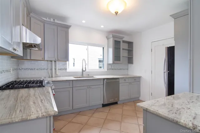 a kitchen with a sink stove and cabinets