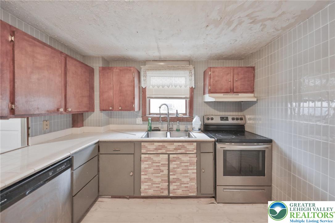 1291 Seidersville Road Bethlehem, PA 18015 - Photo 11 of 56 a kitchen with a stove and cabinets