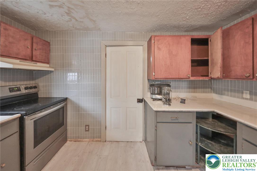 1291 Seidersville Road Bethlehem, PA 18015 - Photo 14 of 56 a kitchen with a sink stove and cabinets