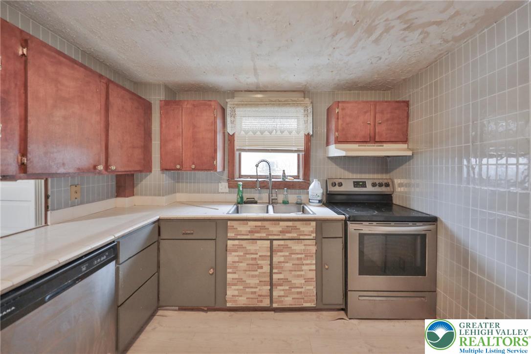 1291 Seidersville Road Bethlehem, PA 18015 - Photo 15 of 56 a kitchen with stainless steel appliances granite countertop a stove a sink and a microwave
