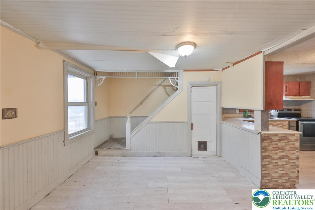 1291 Seidersville Road Bethlehem, PA 18015 - Photo 7 of 56 a view of a hallway to room with wooden floor and windows