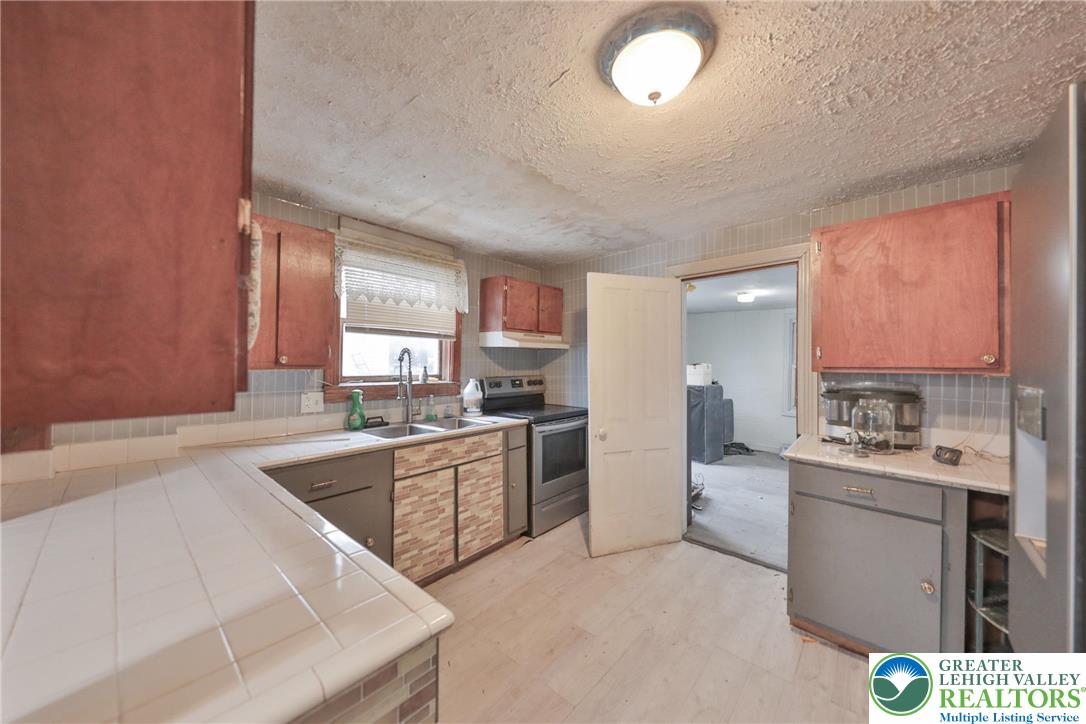 1291 Seidersville Road Bethlehem, PA 18015 - Photo 9 of 56 a kitchen with a sink stove and refrigerator