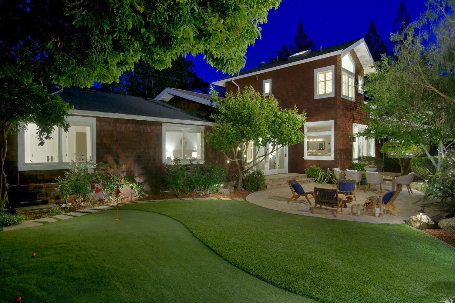 a view of a house with backyard sitting area and garden