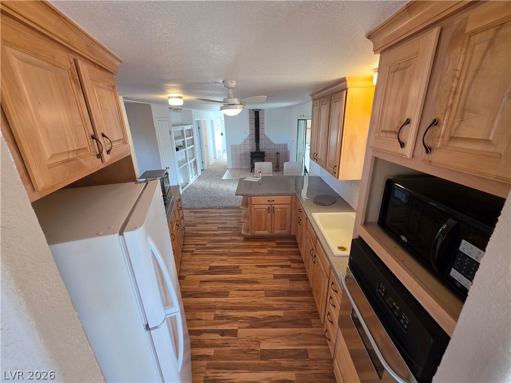 2930 Frehner Ranch Road Pioche, NV 89043 - Photo 6 of 32 A well-equipped kitchen boasts light-toned wooden cabinetry and durable countertops, flowing into a comfortable living space.