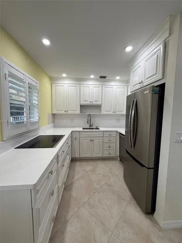 a view of a kitchen with a sink and cabinets