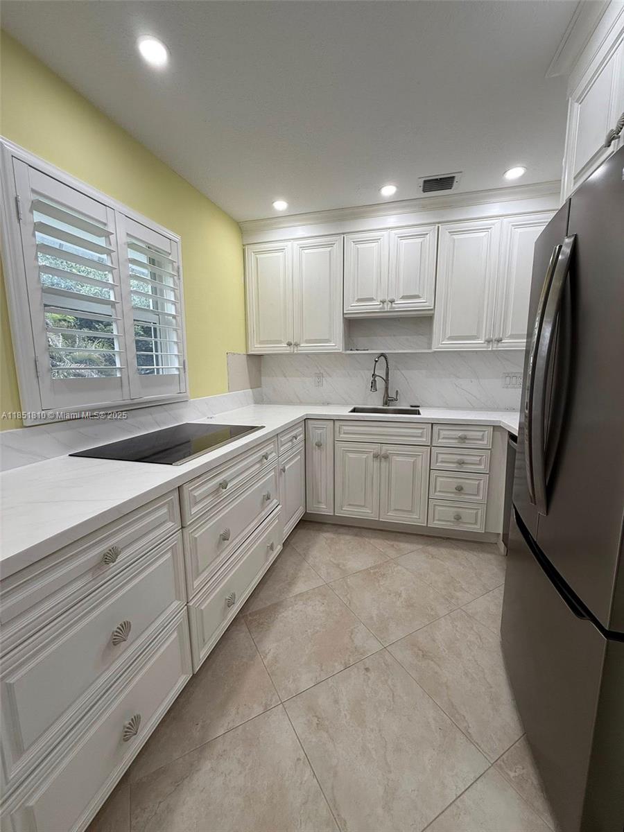 2929 Southeast Ocean Boulevard, Unit 14310 Stuart, FL 34996 - Photo 15 of 73 a kitchen with sink cabinets and window