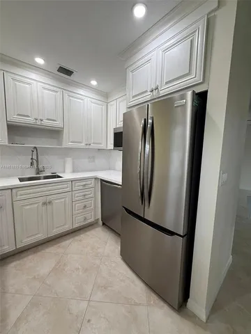 a view of a livingroom with a flat screen tv wooden floor and a ceiling fan