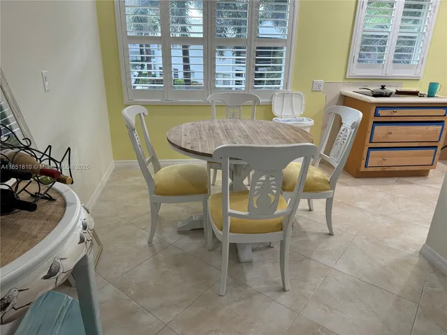 a dining room with furniture and windows