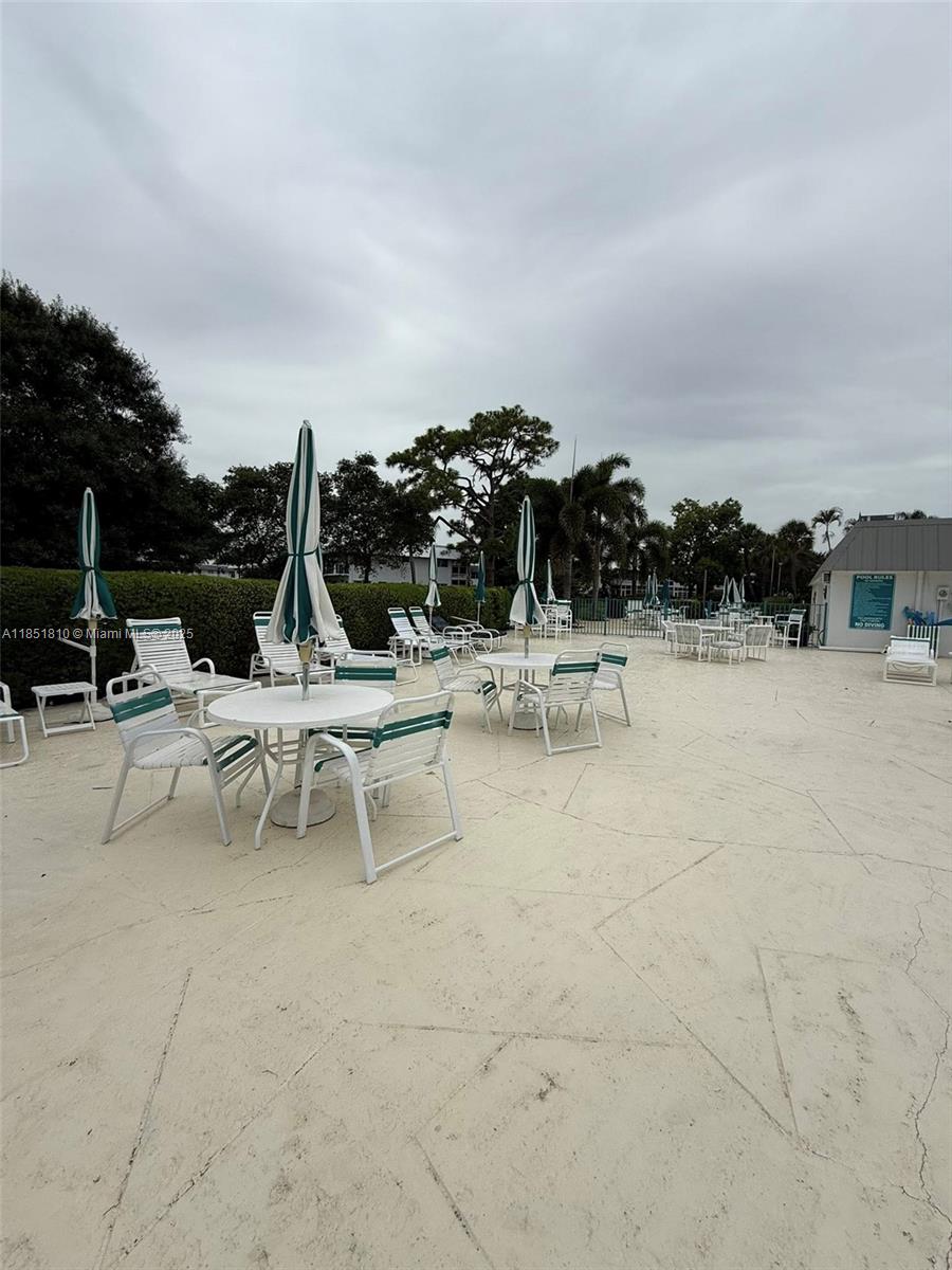 2929 Southeast Ocean Boulevard, Unit 14310 Stuart, FL 34996 - Photo 41 of 73 a view of a terrace with chairs