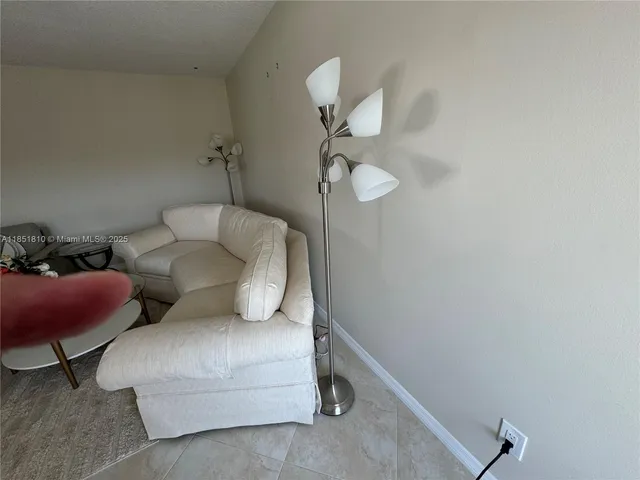 a living room with furniture and a lamp