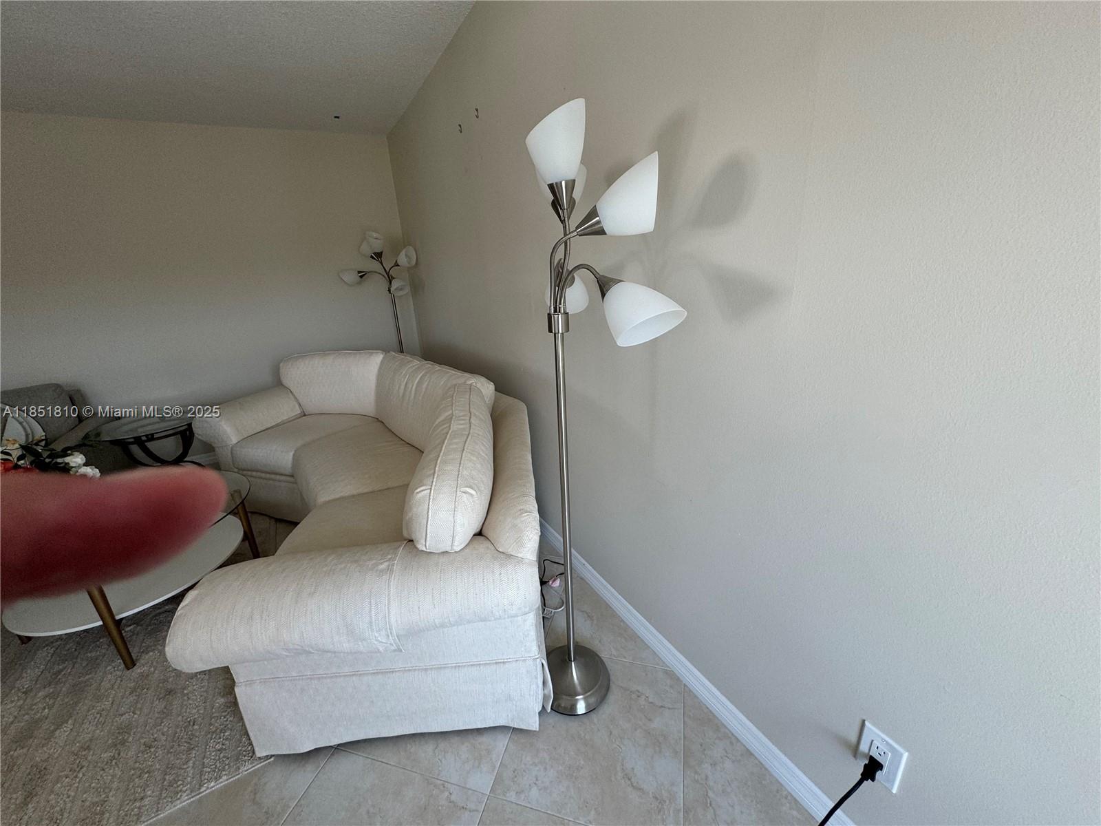 2929 Southeast Ocean Boulevard, Unit 14310 Stuart, FL 34996 - Photo 48 of 73 a living room with furniture and a mirror