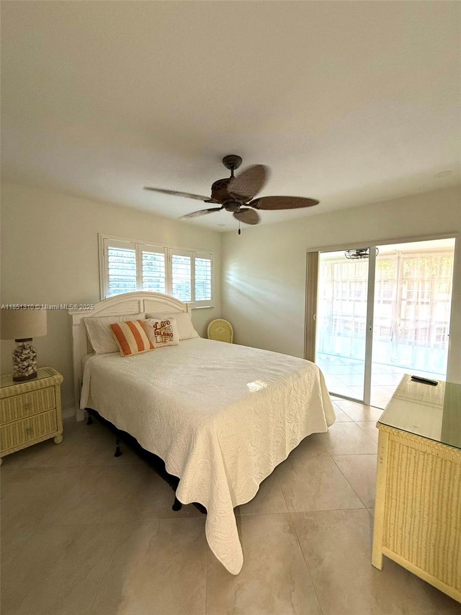 2929 Southeast Ocean Boulevard, Unit 14310 Stuart, FL 34996 - Photo 5 of 73 a bed sitting in a bedroom next to a window