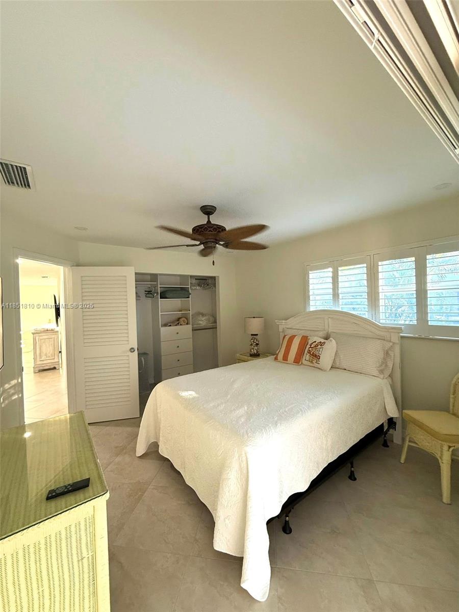2929 Southeast Ocean Boulevard, Unit 14310 Stuart, FL 34996 - Photo 64 of 73 a bedroom with a bed and a window
