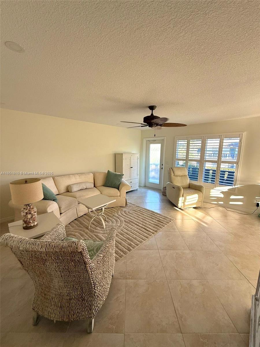 2929 Southeast Ocean Boulevard, Unit 14310 Stuart, FL 34996 - Photo 68 of 73 a living room with furniture and a large window