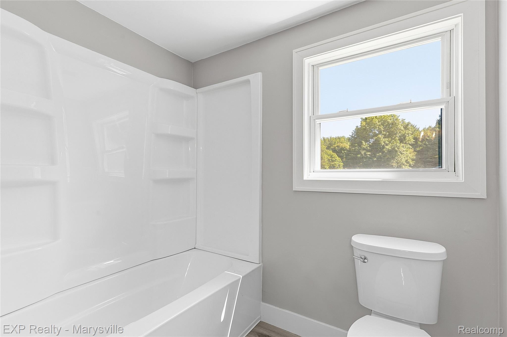 13739 Yale Road Yale, MI 48097 - Photo 19 of 50 White wall-mounted tub and shower combination with integrated shelving