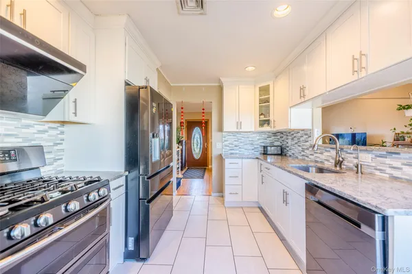 a kitchen with stainless steel appliances granite countertop a stove and a sink