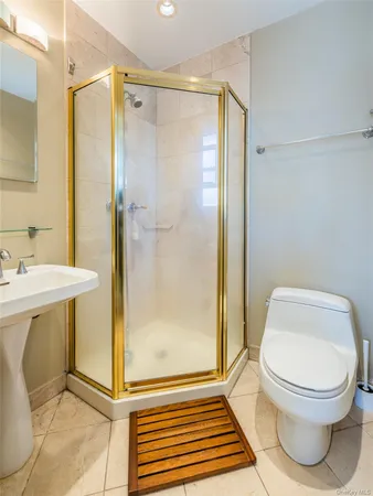 a bathroom with a toilet and a shower