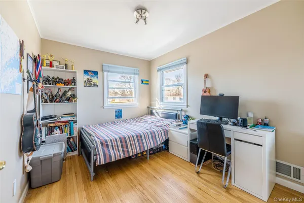 a bedroom with a bed and a desk