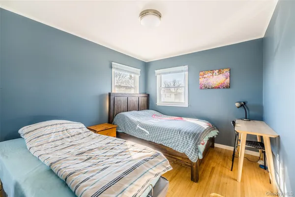 a bedroom with beds and a window