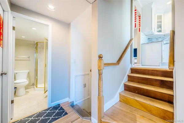 a view of entryway and hall with wooden floor
