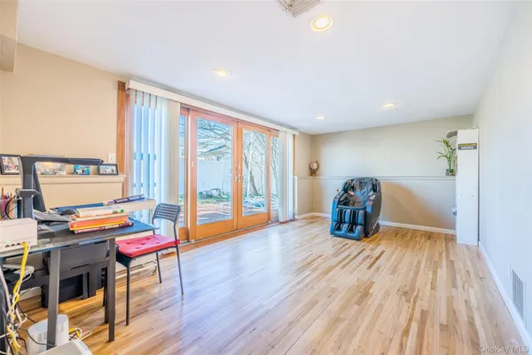 a bedroom with furniture and a wooden floor