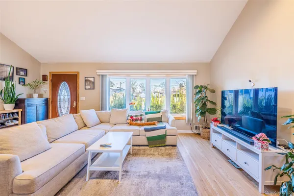 a living room with furniture fireplace and a window