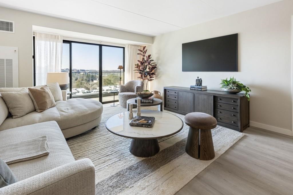 2460 Peachtree Road Northeast, Unit 514 Atlanta, GA 30305 - Photo 11 of 36 a living room with furniture a flat screen tv and a large window