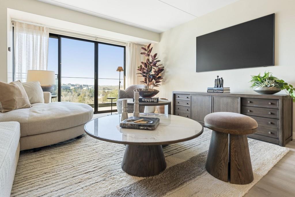 2460 Peachtree Road Northeast, Unit 514 Atlanta, GA 30305 - Photo 13 of 36 a living room with furniture and a flat screen tv