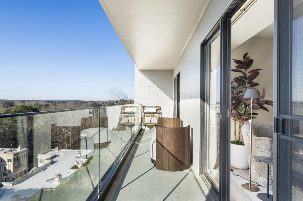 2460 Peachtree Road Northeast, Unit 514 Atlanta, GA 30305 - Photo 17 of 36 a balcony with furniture and a floor to ceiling window