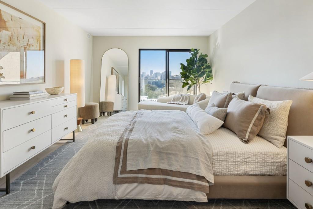 2460 Peachtree Road Northeast, Unit 514 Atlanta, GA 30305 - Photo 22 of 36 a large bed sitting in a bedroom next to a window